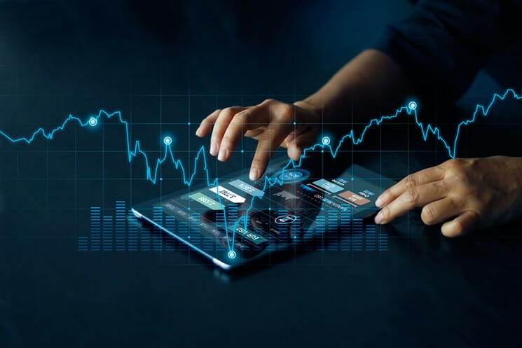 Person using tablet for banking investment stock exchange trading blue graph concept