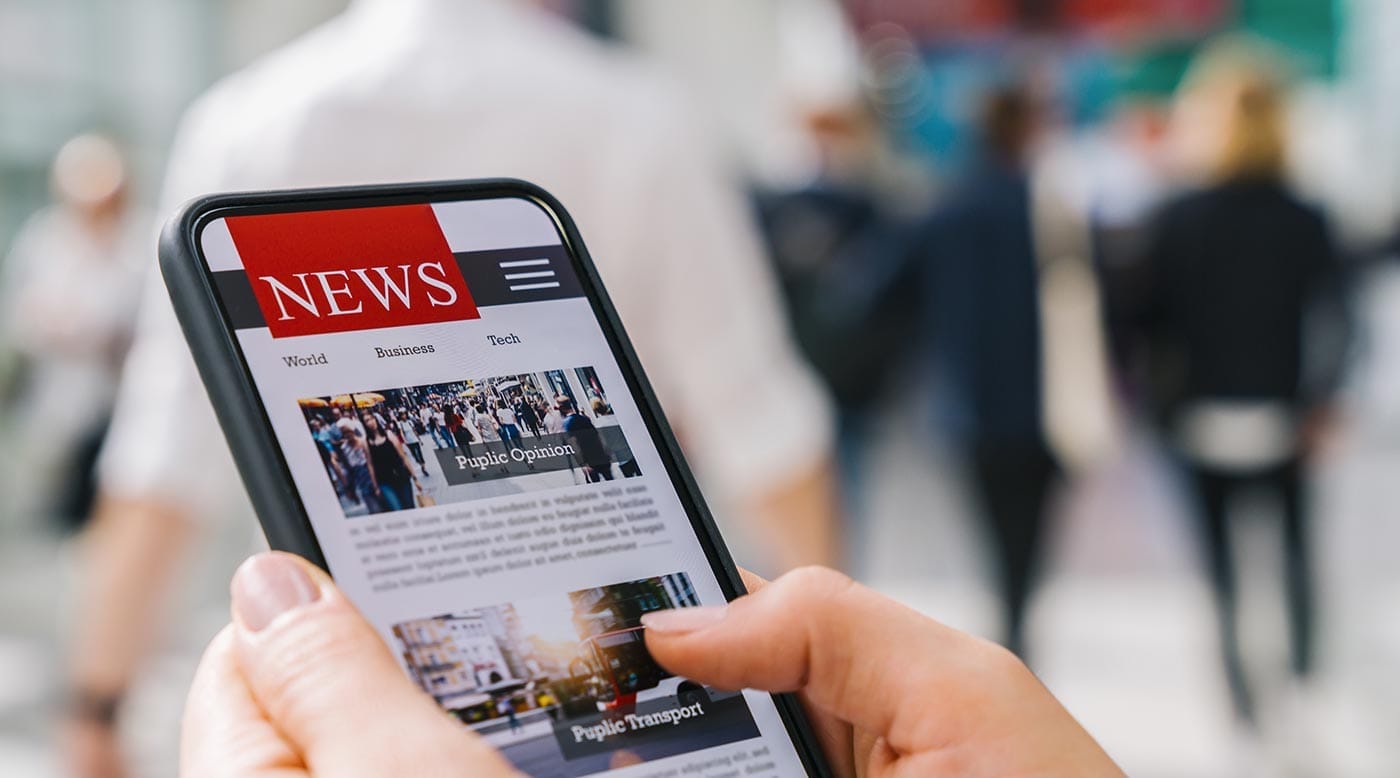 Day trader reading news on mobile phone close up