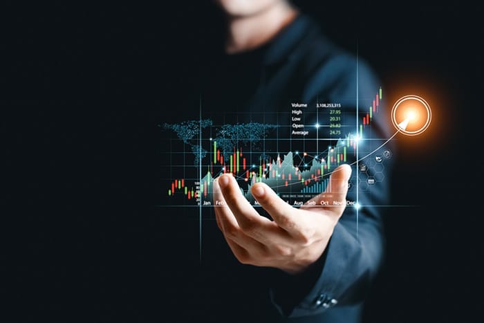 Forex trading chart patterns spiraling up from day trader’s outstretched hand
