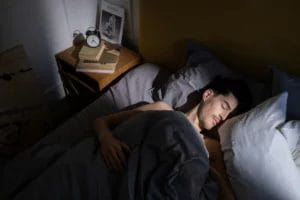 Man sleeping in bed.